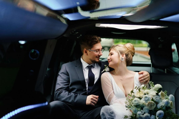 A couple in wedding limousine